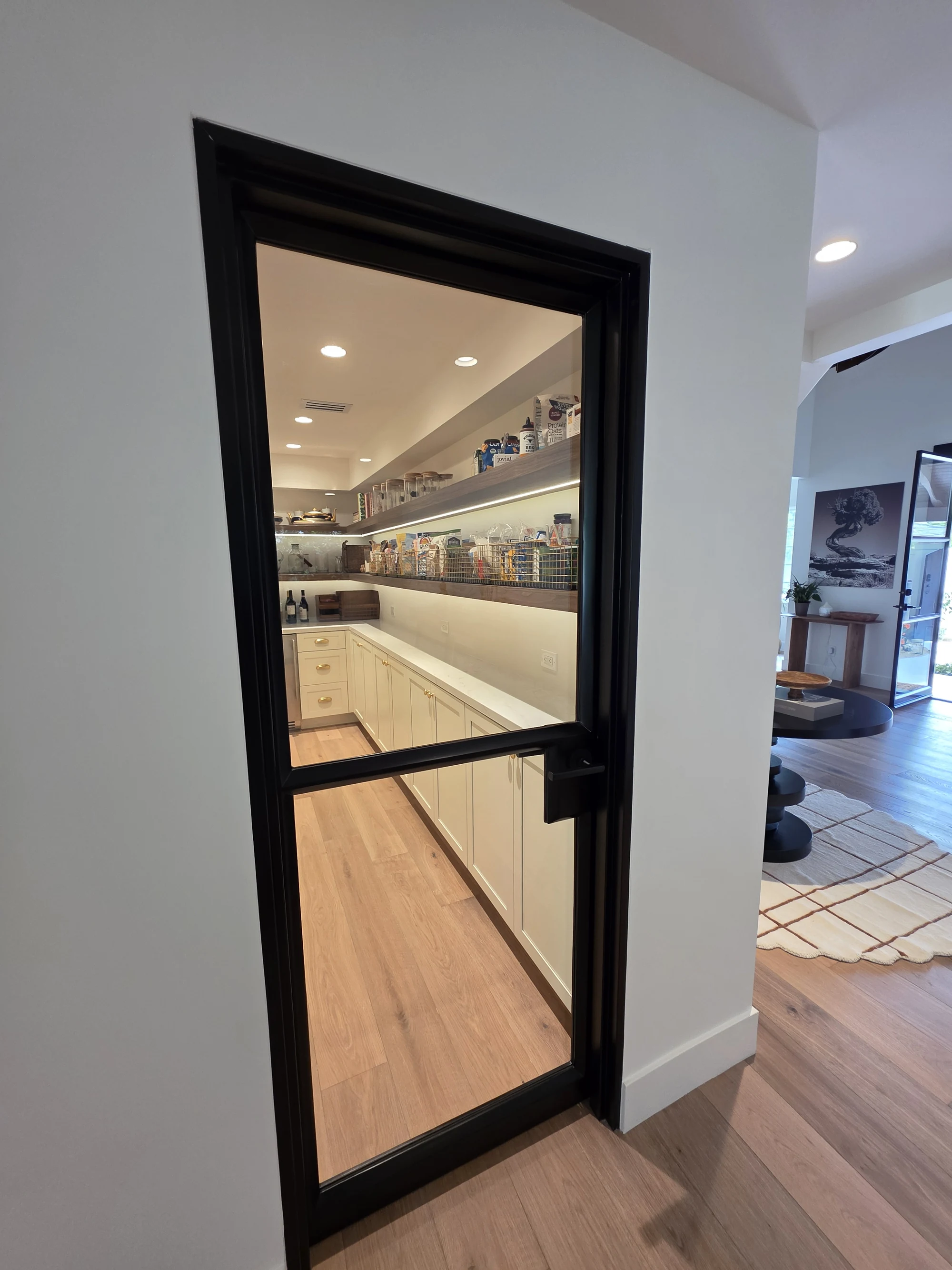 Glazed interior door connecting the kitchen and adjacent space
