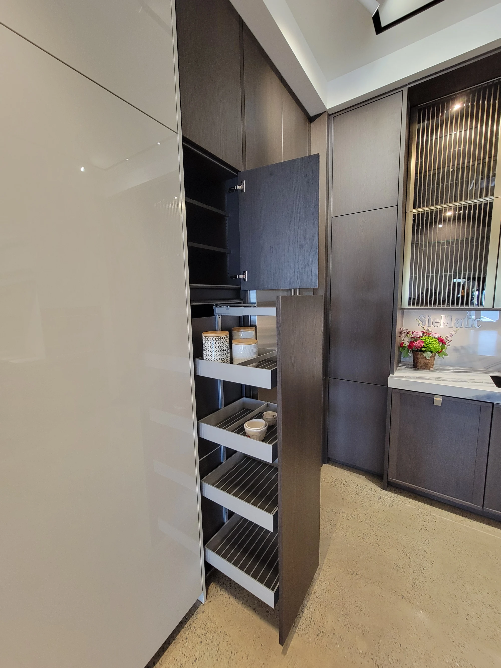 Installed pull-out storage cabinet beside a stone worktop